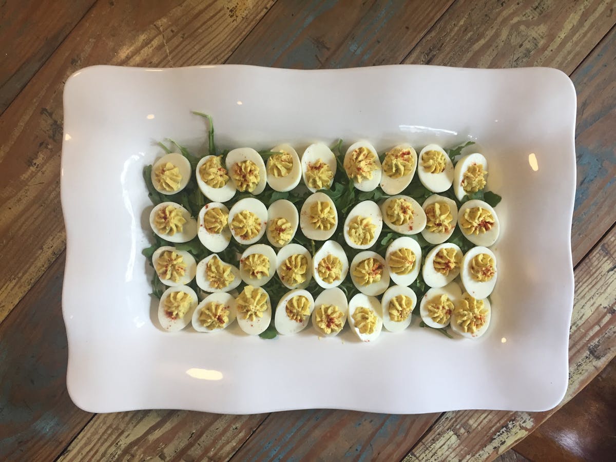 a plate of food sitting on top of a wooden cutting board