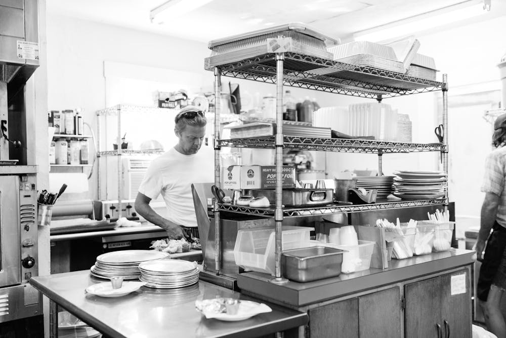 a person cooking in a kitchen preparing food