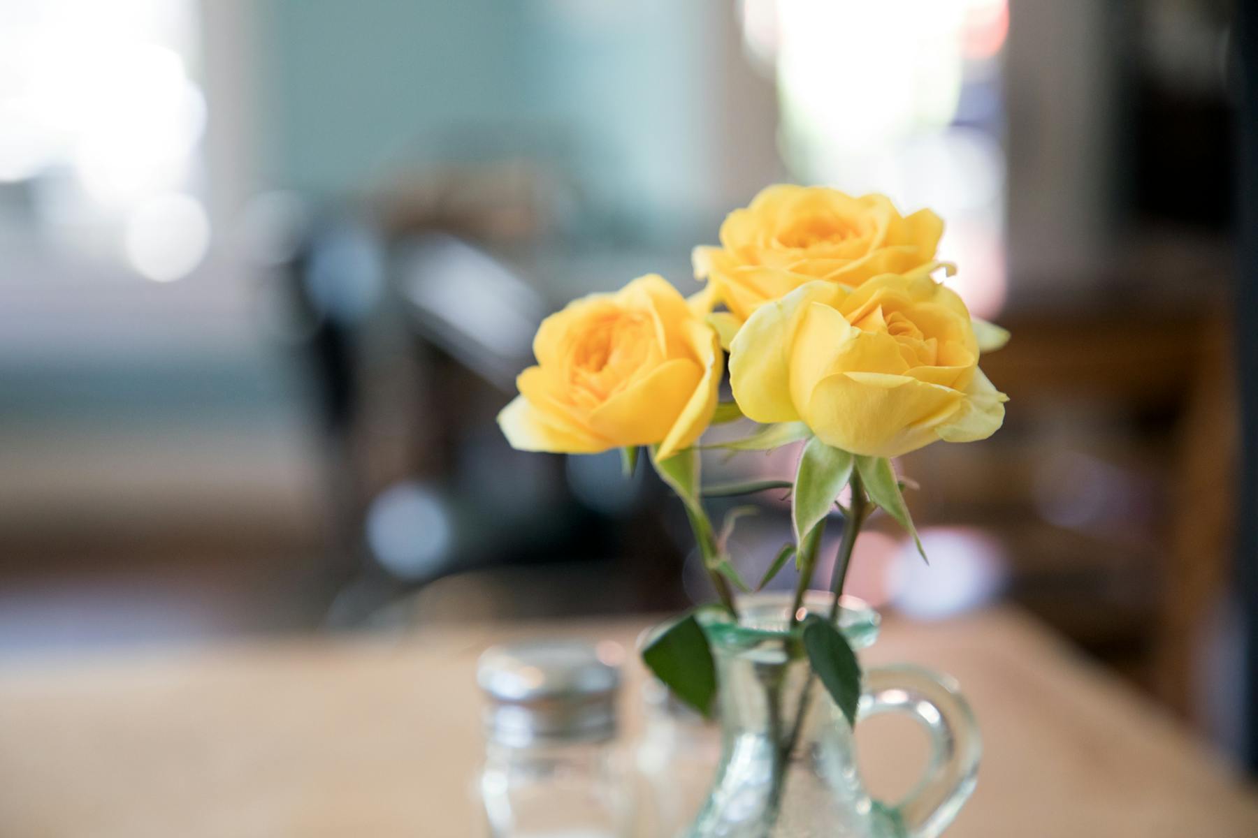 a vase filled with flowers sitting on a table