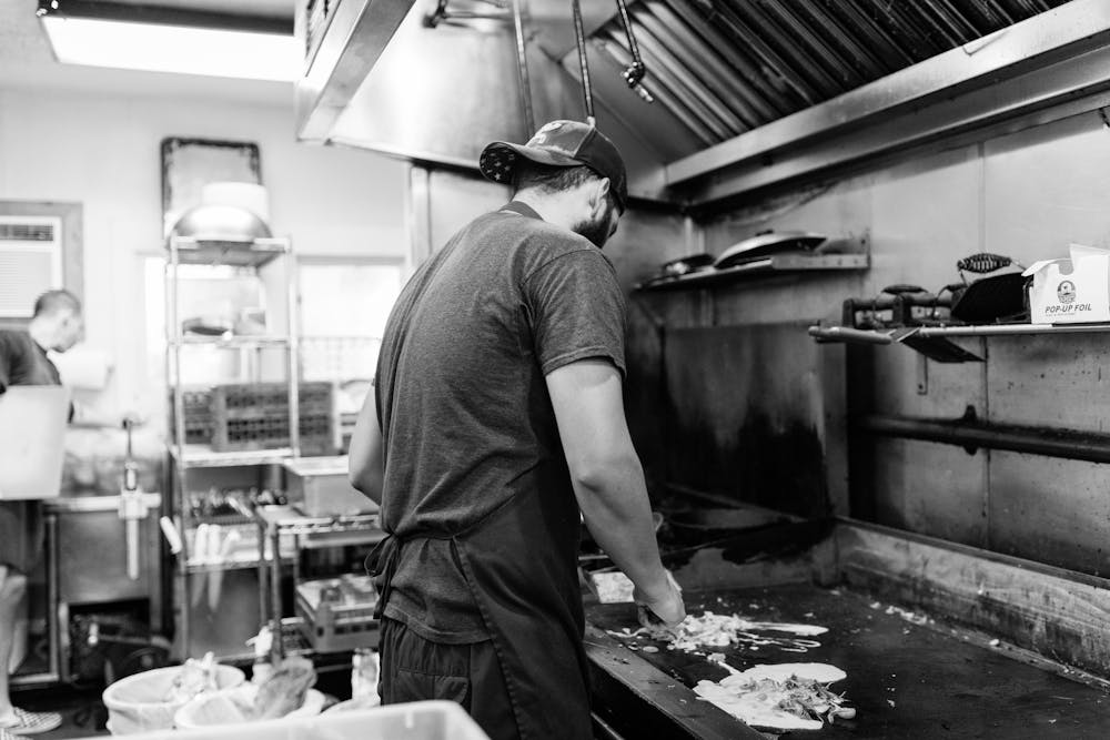 a person standing in a kitchen preparing food