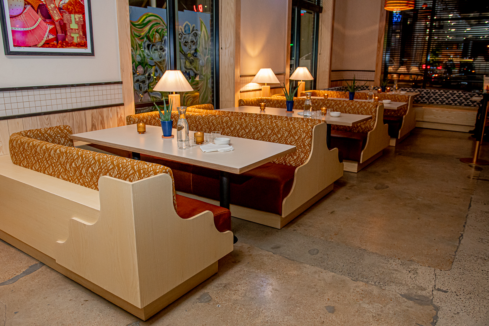 a room filled with furniture and vase of flowers on a table