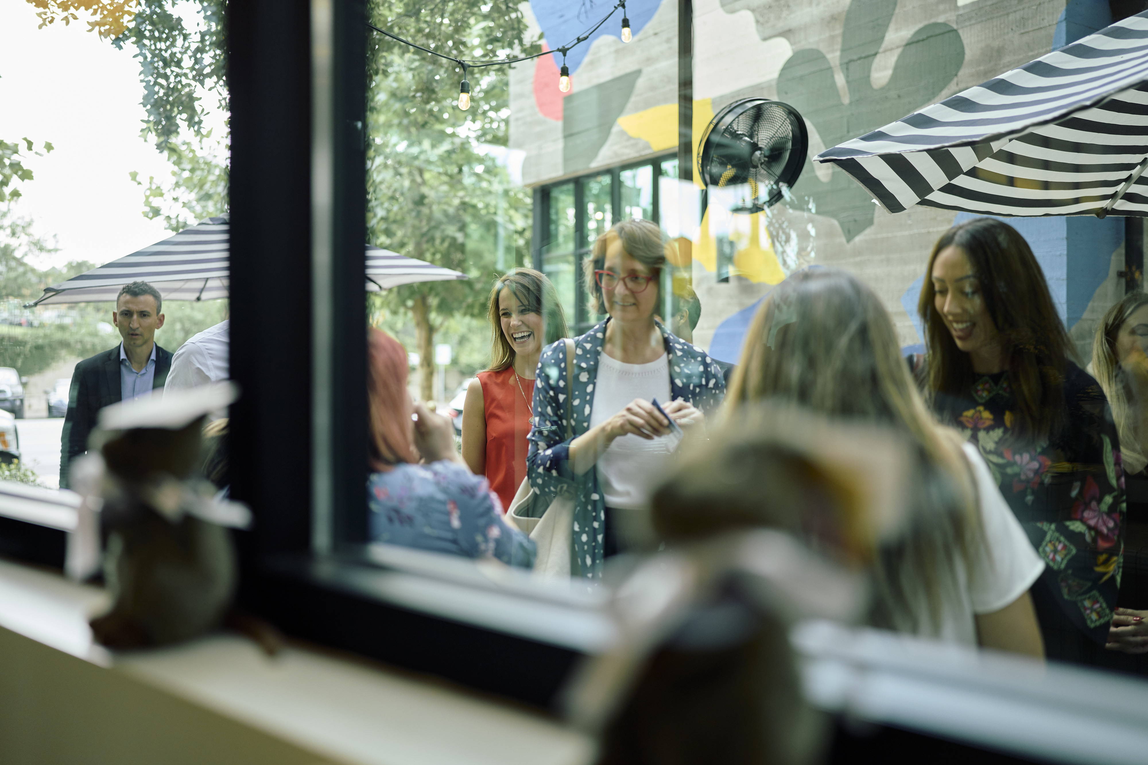 a group of people sitting at a table in a restaurant