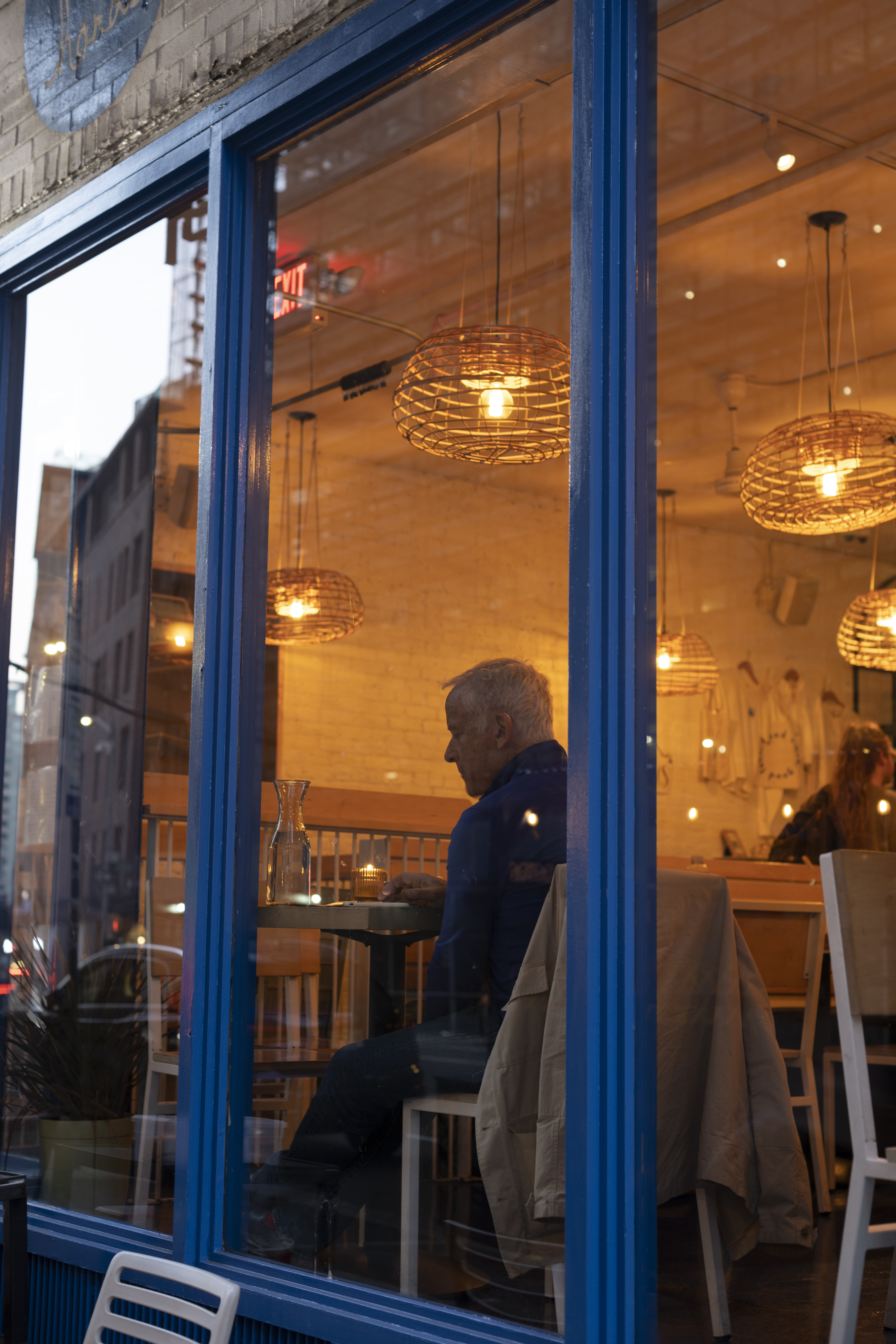 a man sitting at a table in a restaurant