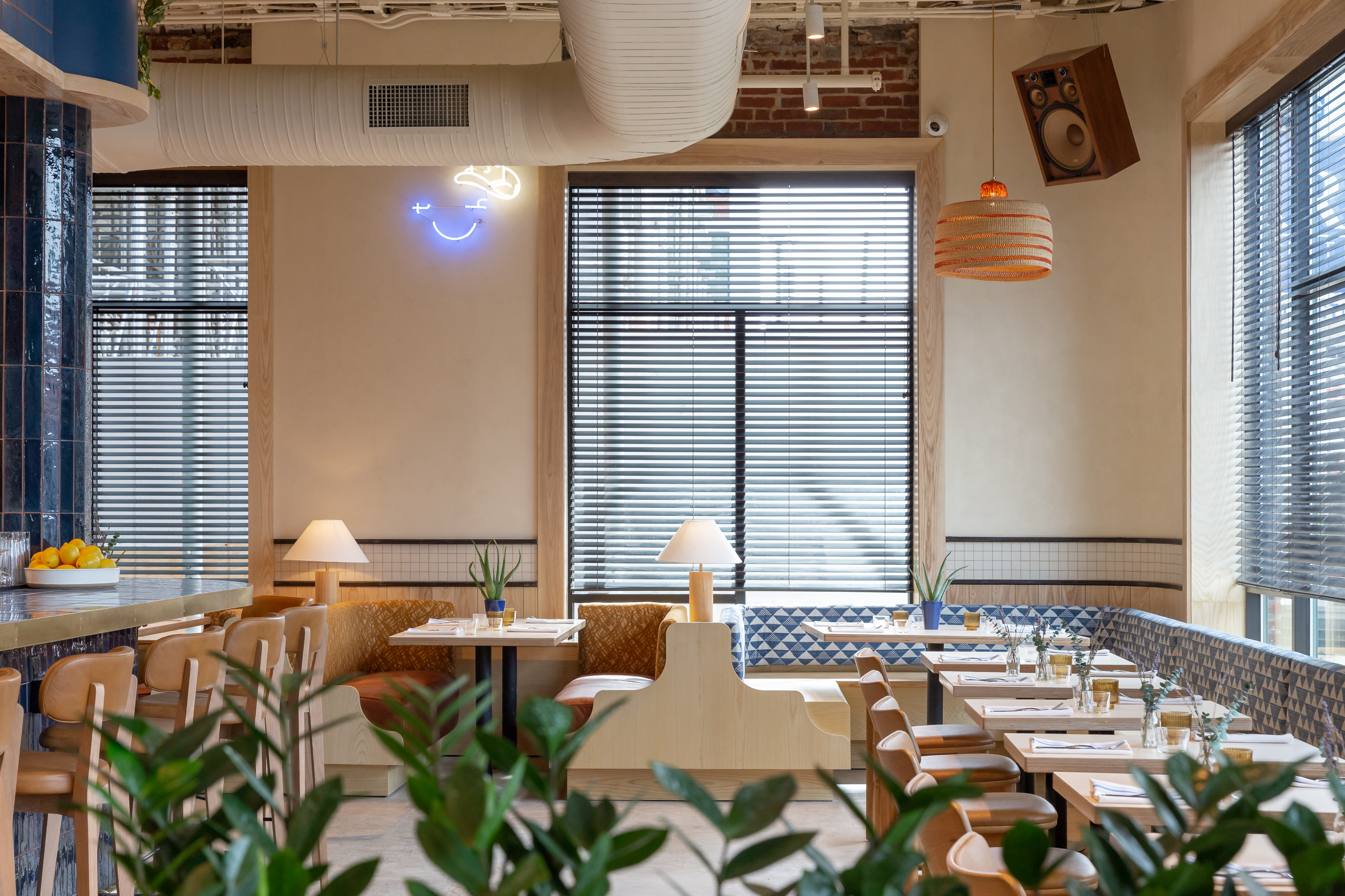 a room filled with furniture and vase of flowers on a table