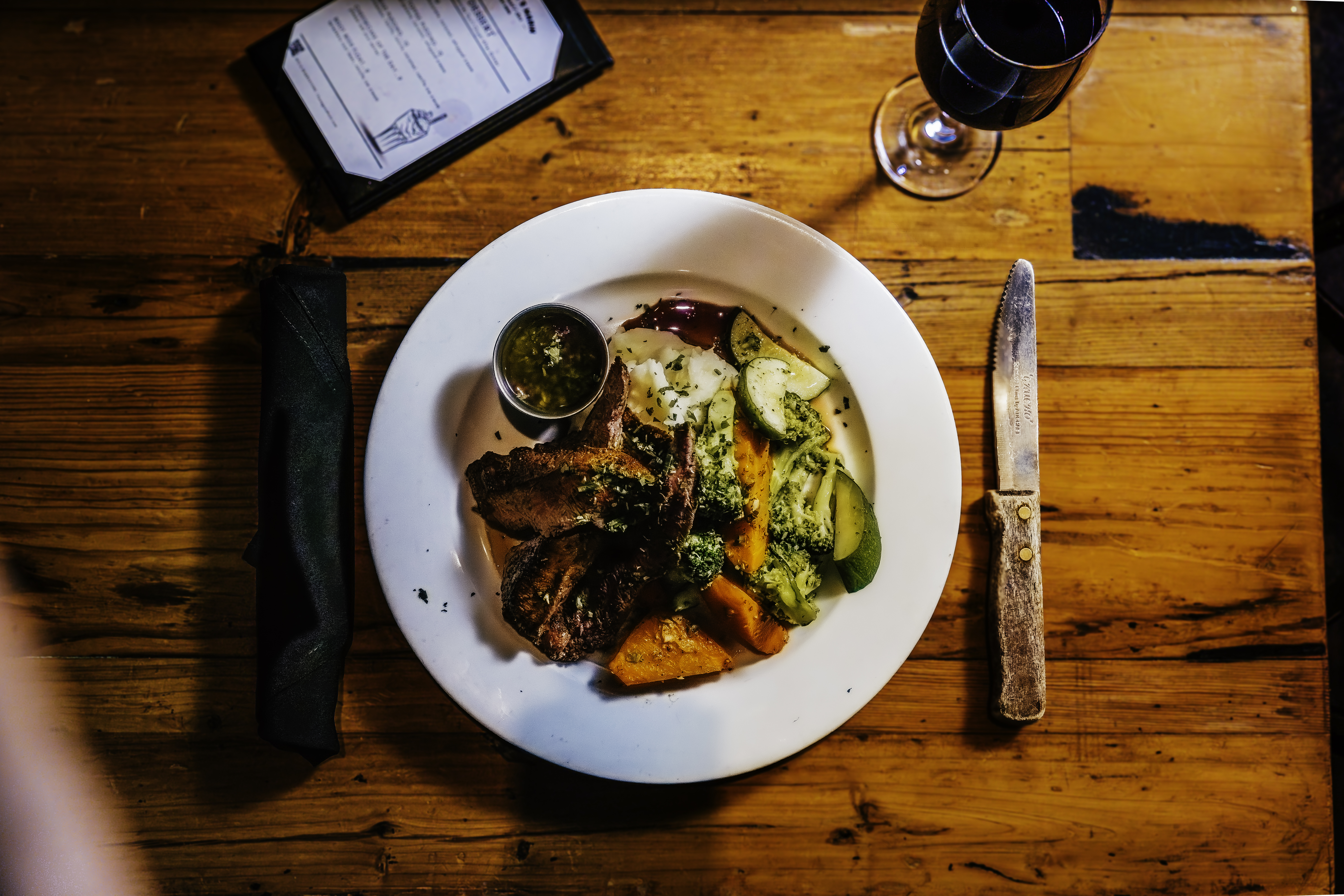 a plate of food sitting on top of a wooden table