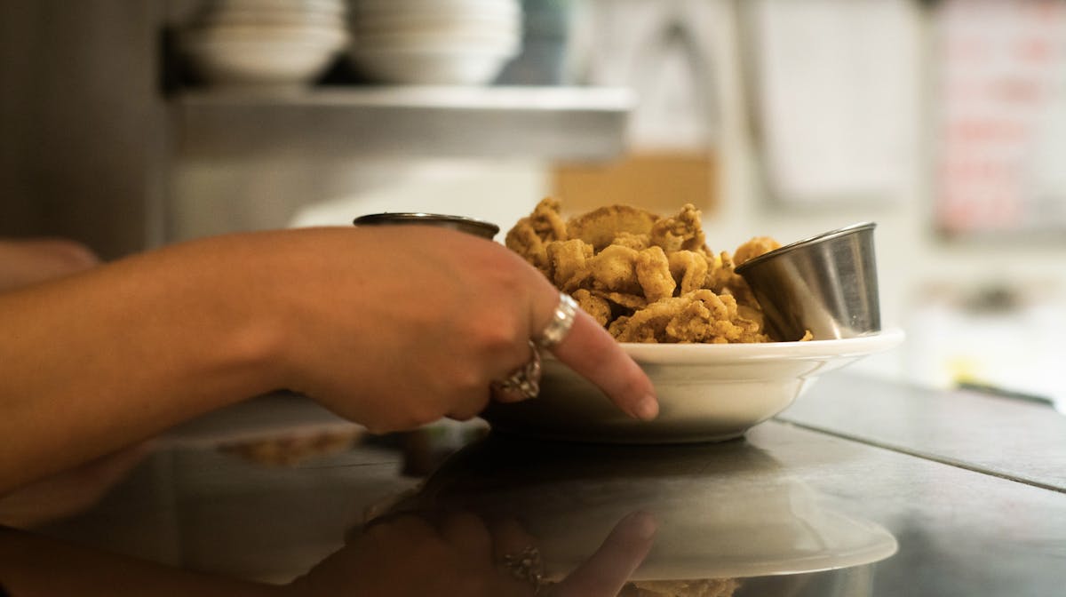 a person sitting at a table with a plate of food