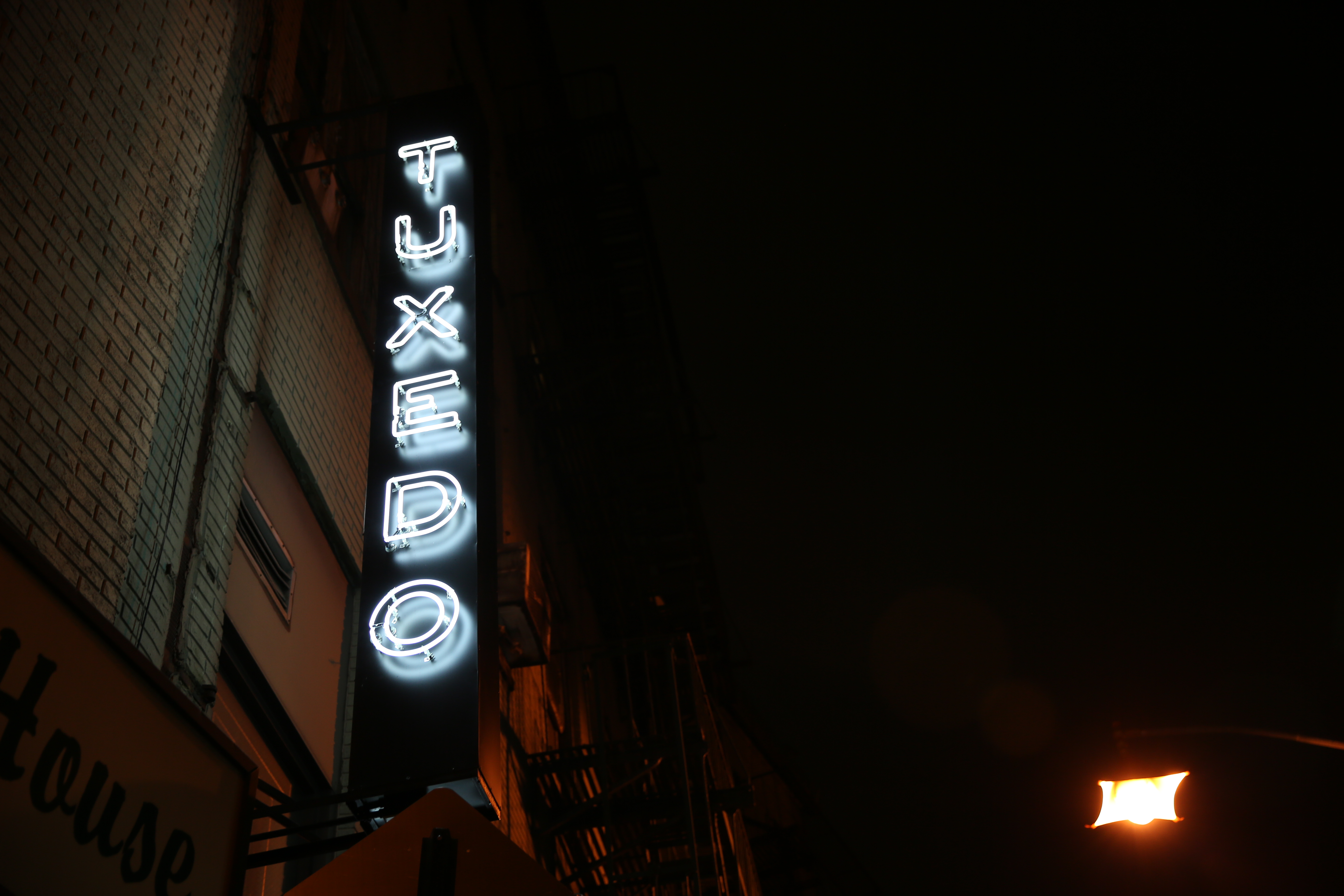 a sign lit up at night
