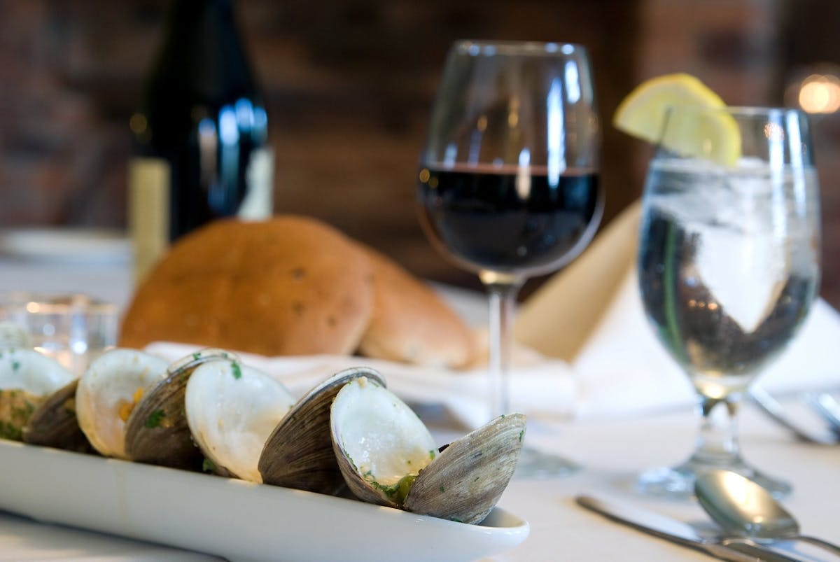 a plate of food and glasses of wine