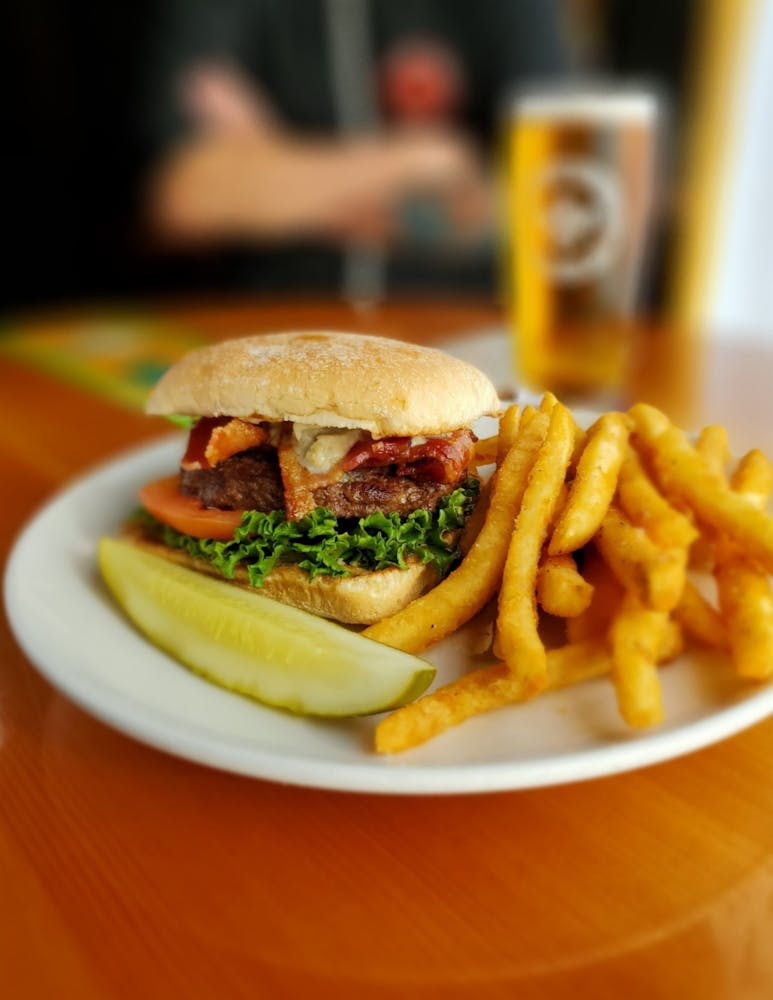 a close up of a sandwich and fries on a plate