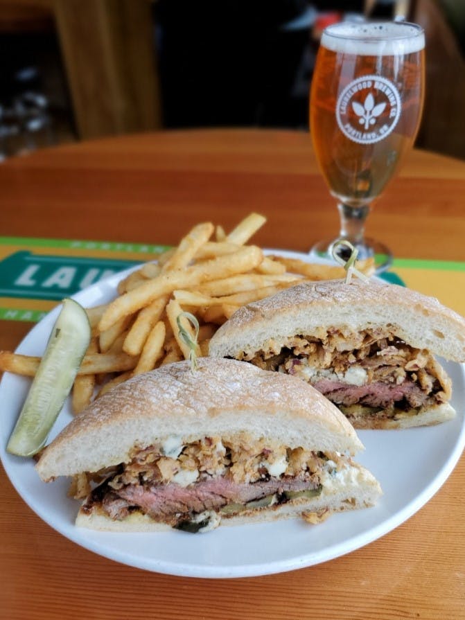 a sandwich sitting on top of a plate of food on a table