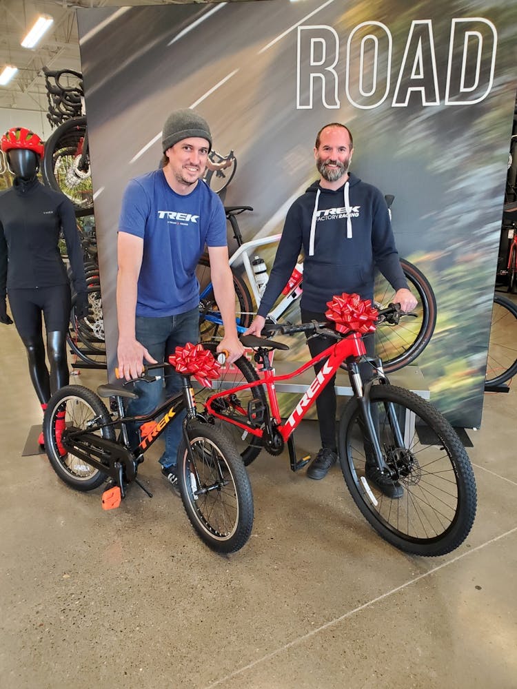 a group of people standing next to a bicycle