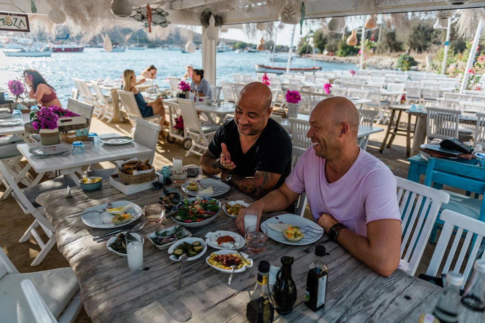 a group of people sitting at a table eating food