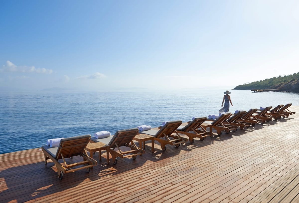 a chair sitting in front of a body of water