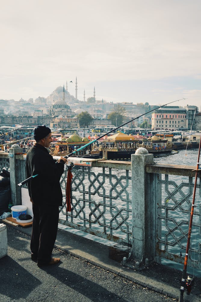 a man standing on a bridge over a body of water