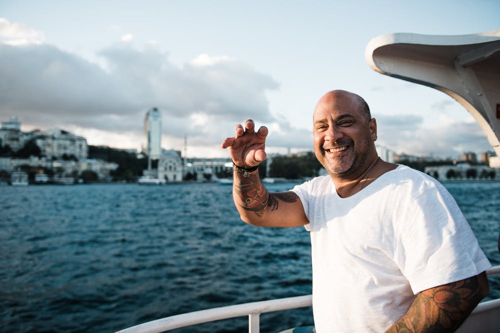 a man standing next to a body of water