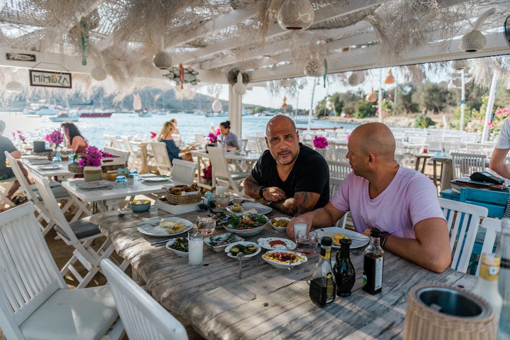 a group of people sitting at a picnic table