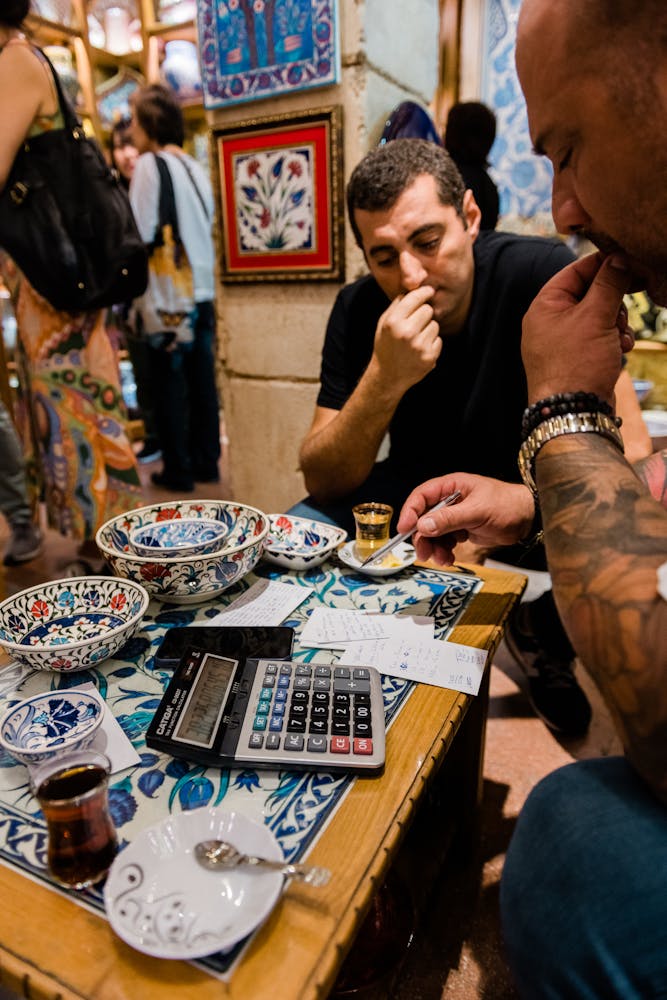 a group of people standing around a table