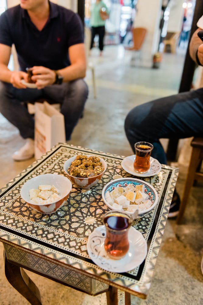 a person sitting at a table with a cake