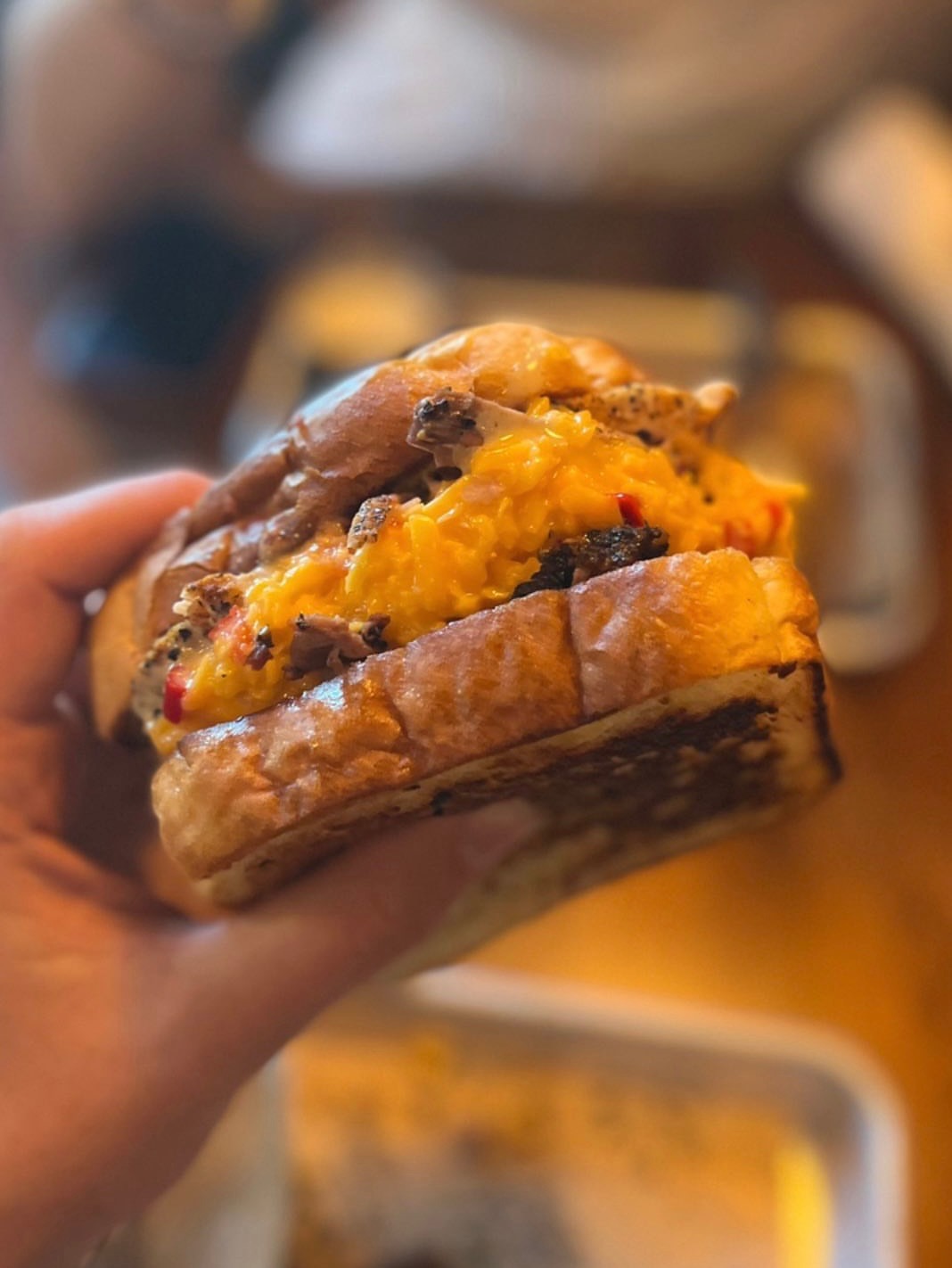a close up of a hand holding a piece of food