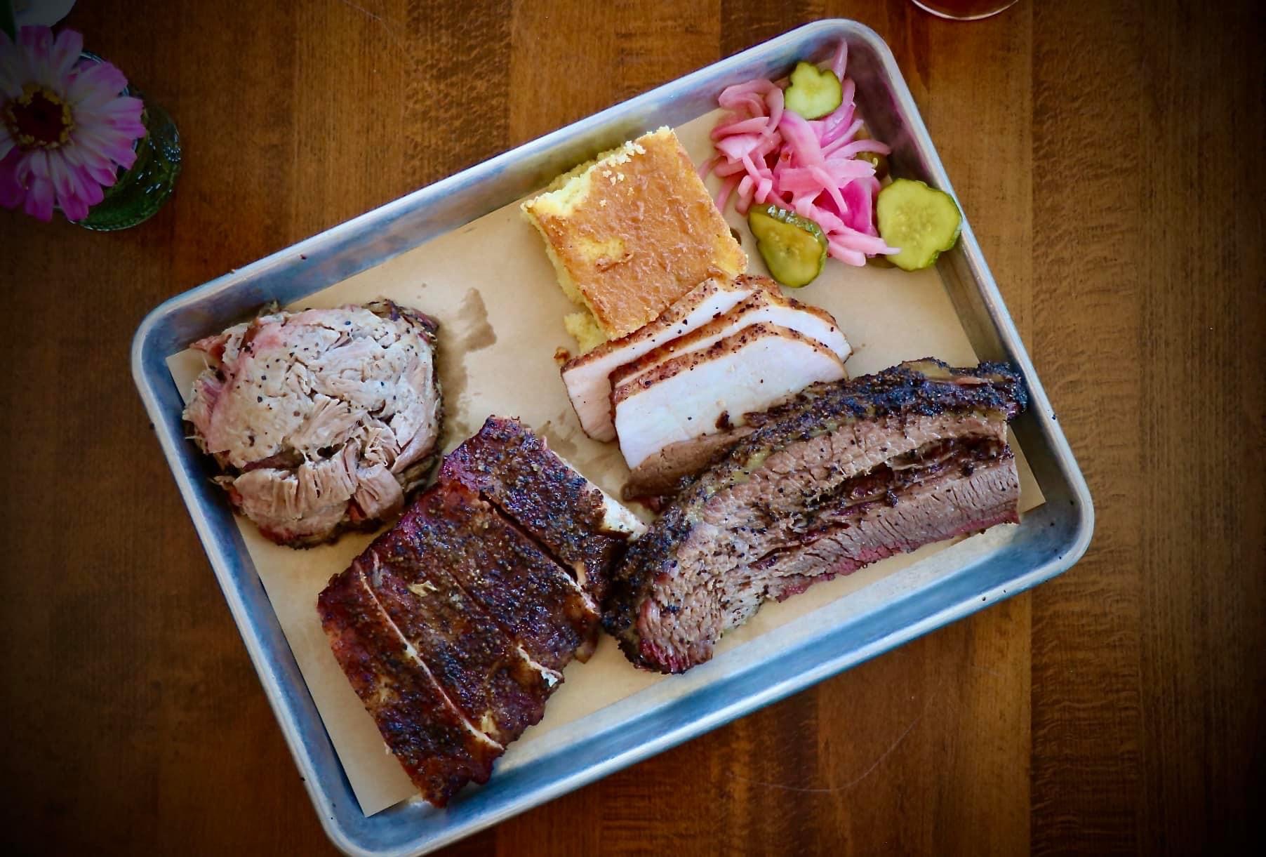 a plate of food with a slice of cake on a table