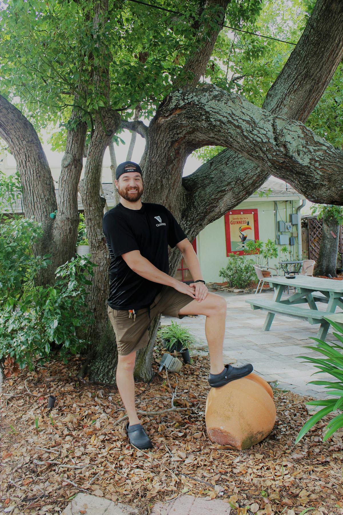 a man standing next to a tree