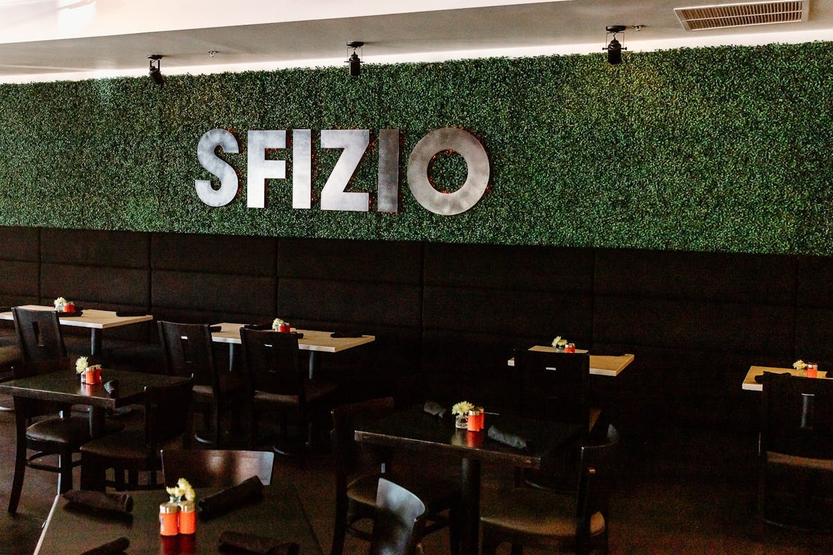 SFIZIO Sign on green wall in dining room
