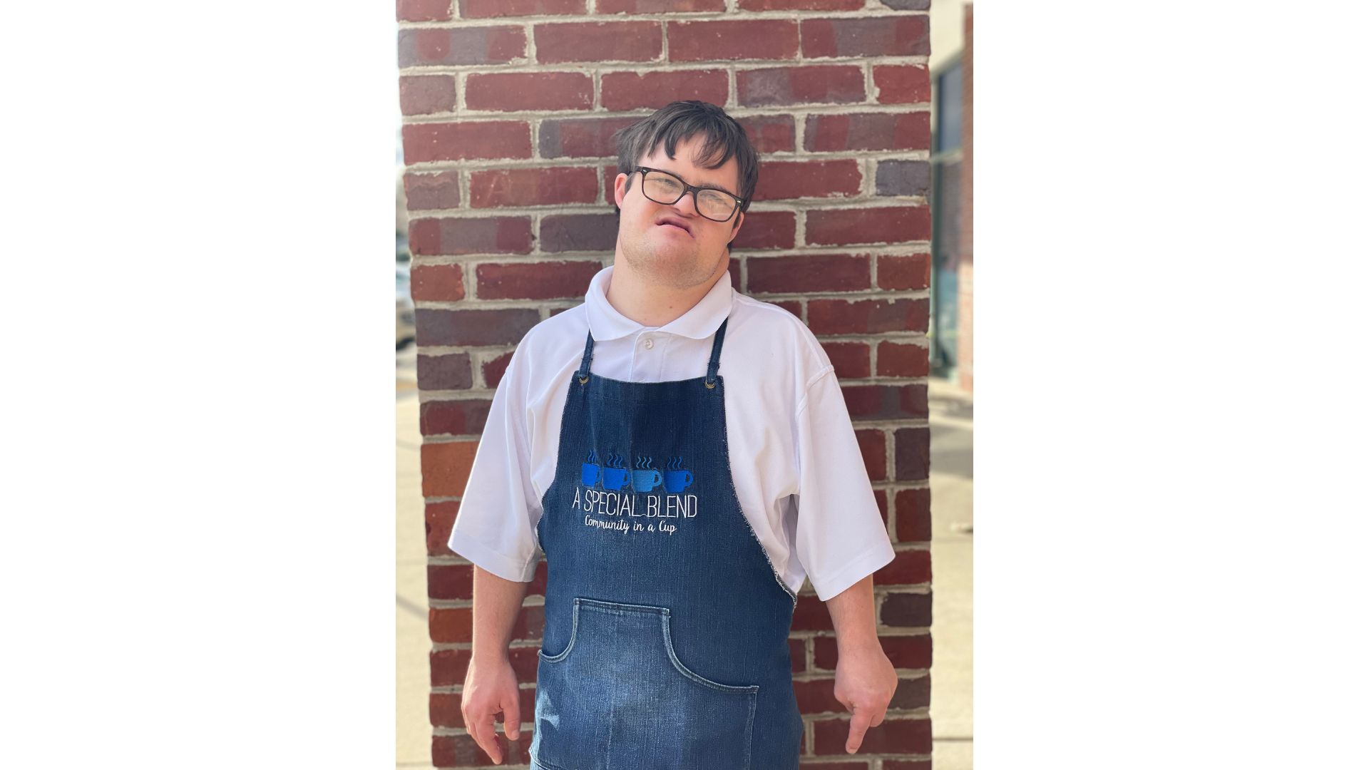 a person standing in front of a brick wall