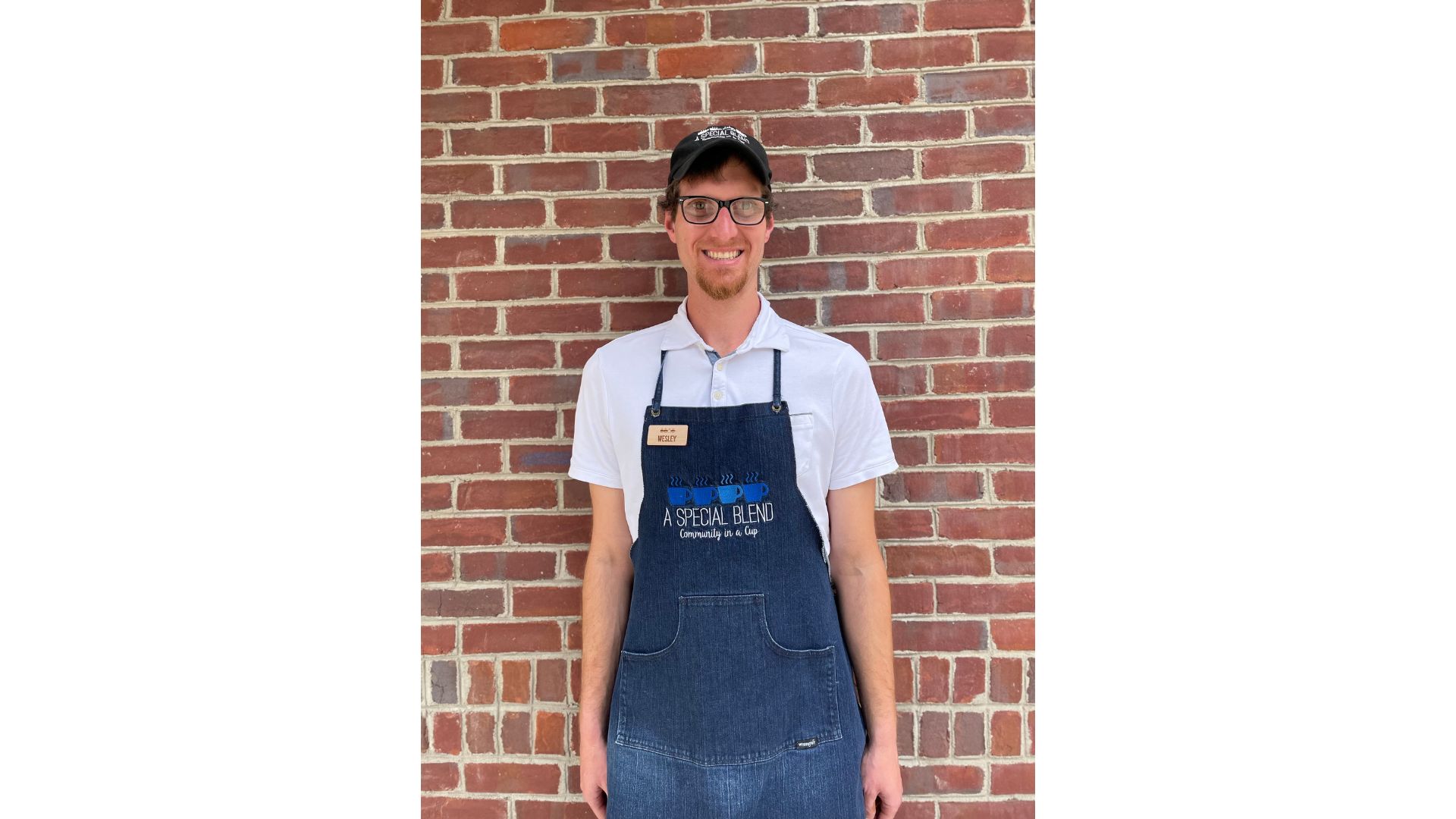 a person standing in front of a brick wall