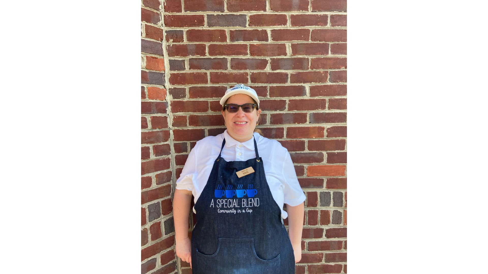 a person standing next to a brick wall