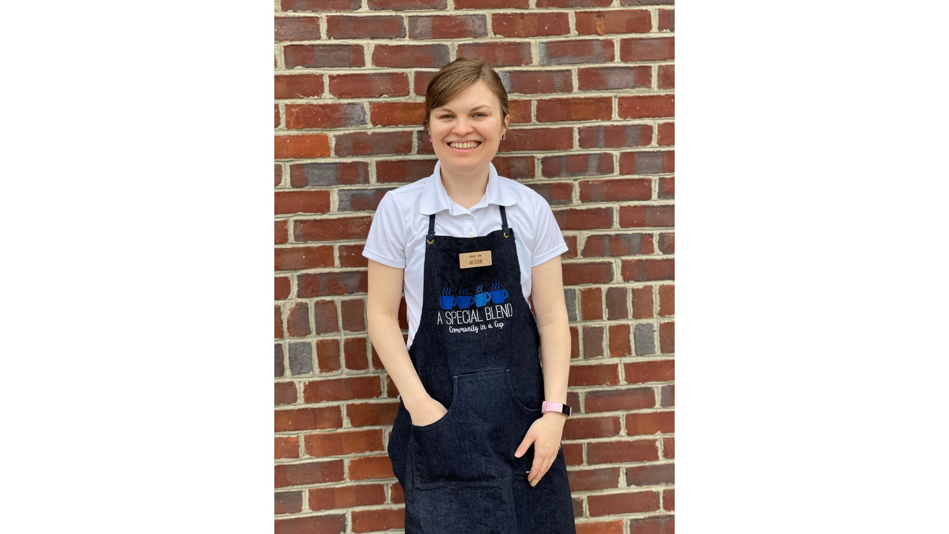 a person standing in front of a brick wall