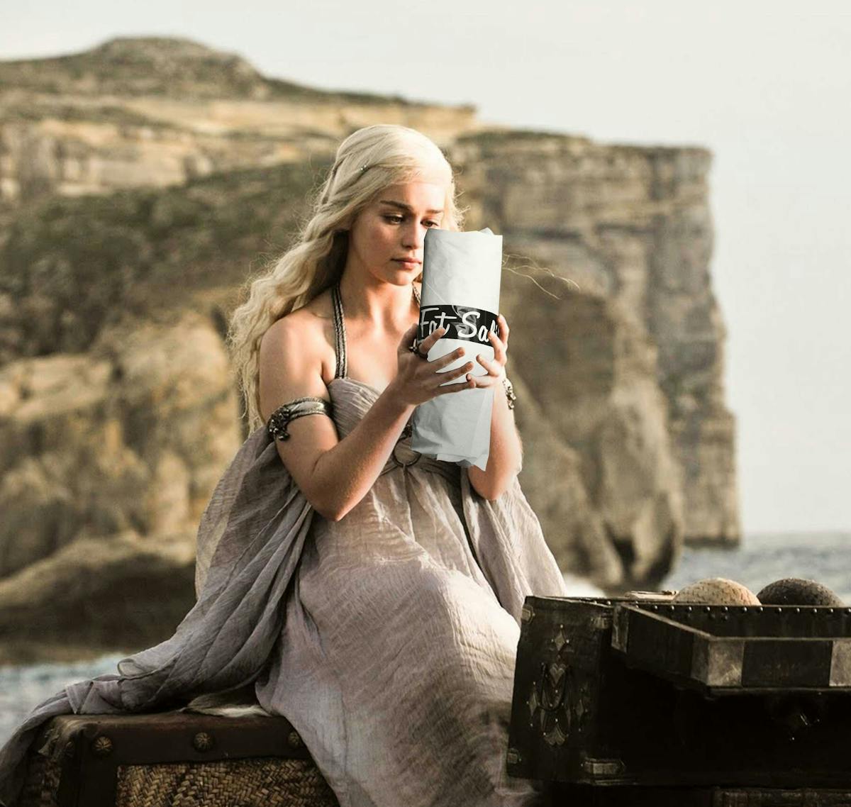 Daenerys Targaryen from Game of Thrones holding and admiring a giant Fat Sal's fat sandwich on a rocky coast