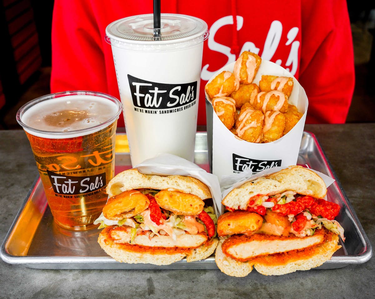 Fat Sal’s sandwich combo featuring a spicy chicken sandwich with cheese puffs, tater tots with sauce, a large drink, and a beer