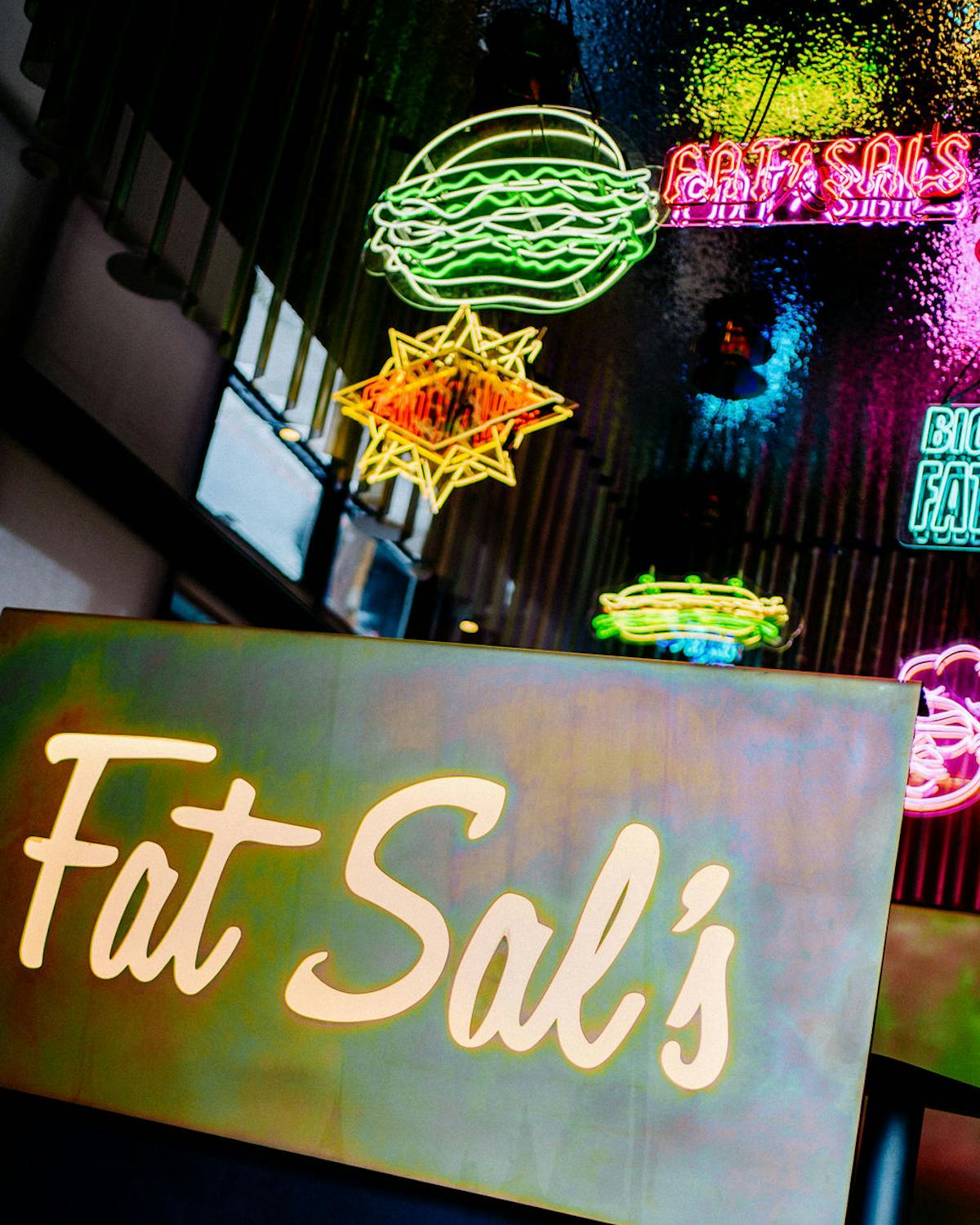 Interior signage and neon lights at Fat Sal’s Studio City location, featuring a glowing Fat Sal’s logo and colorful diner-style decor