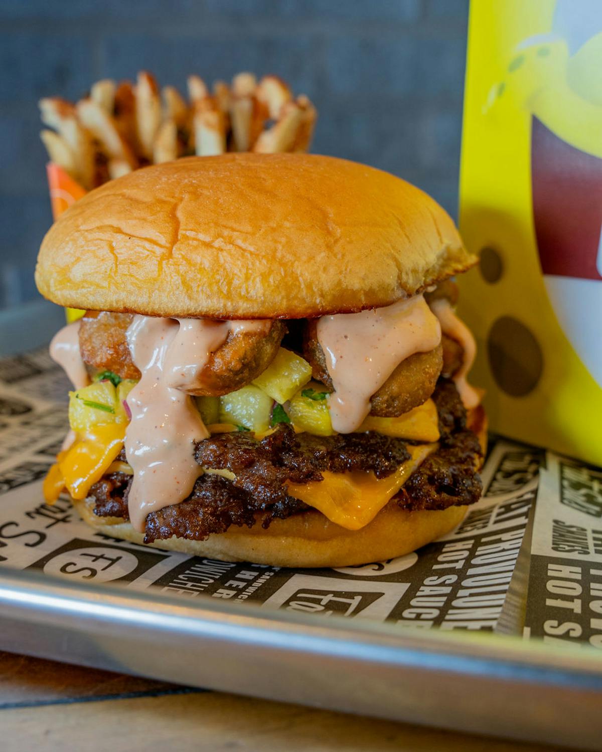 Quick bites burger with double patties, crispy toppings, and special sauce served with fries