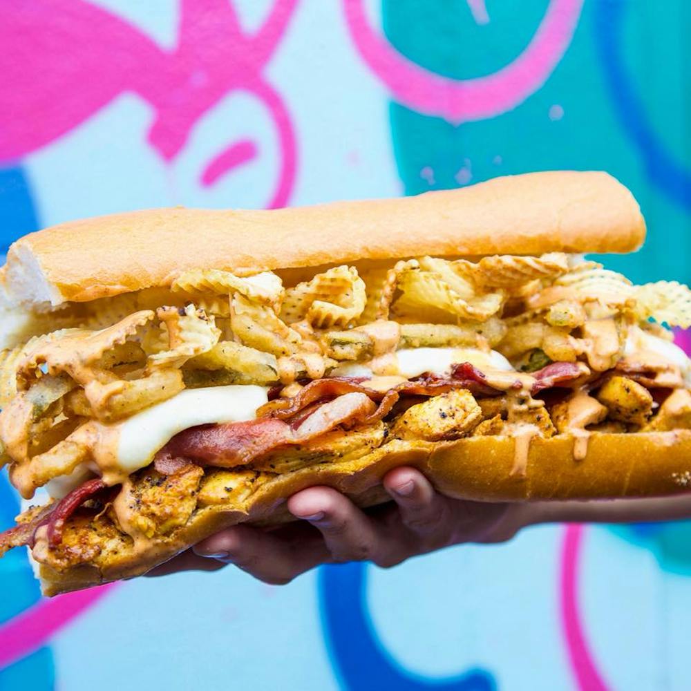 a hand holding a hot dog