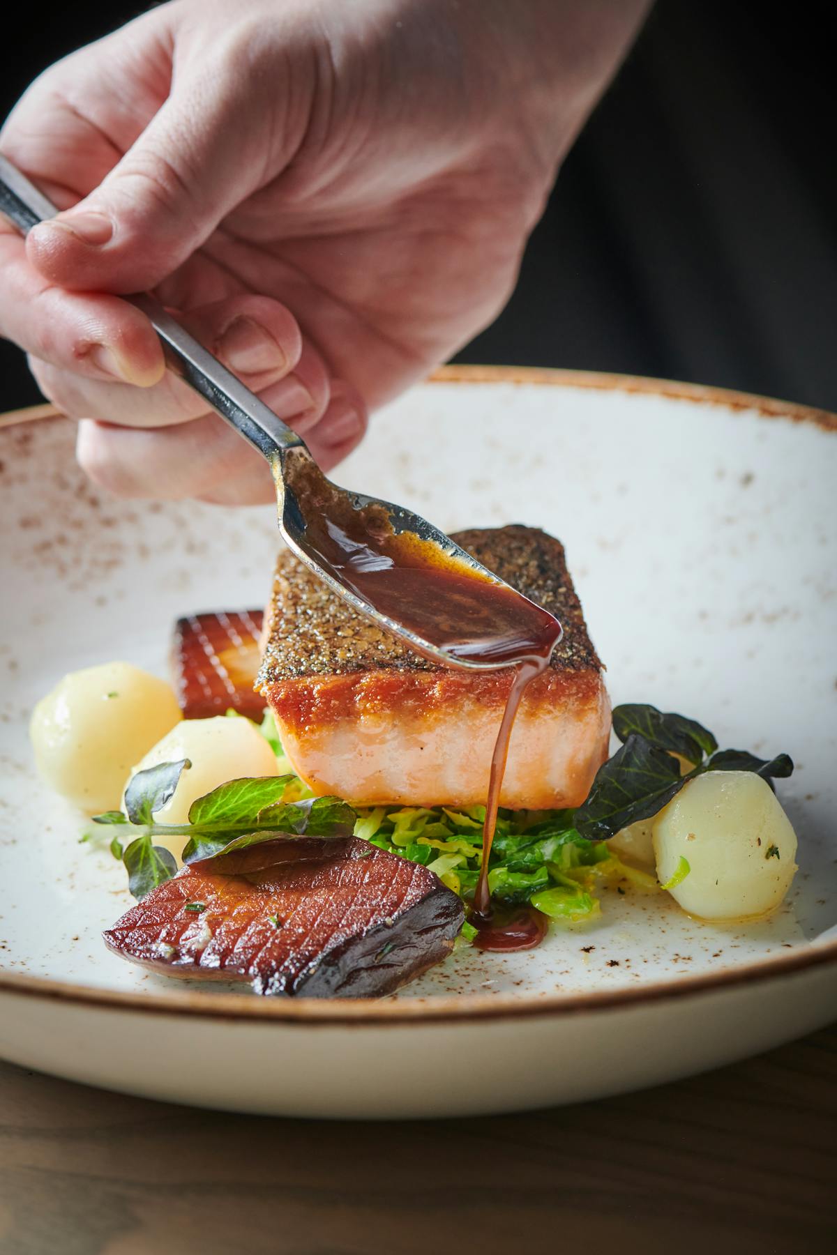 a person holding a plate of food with a fork and knife