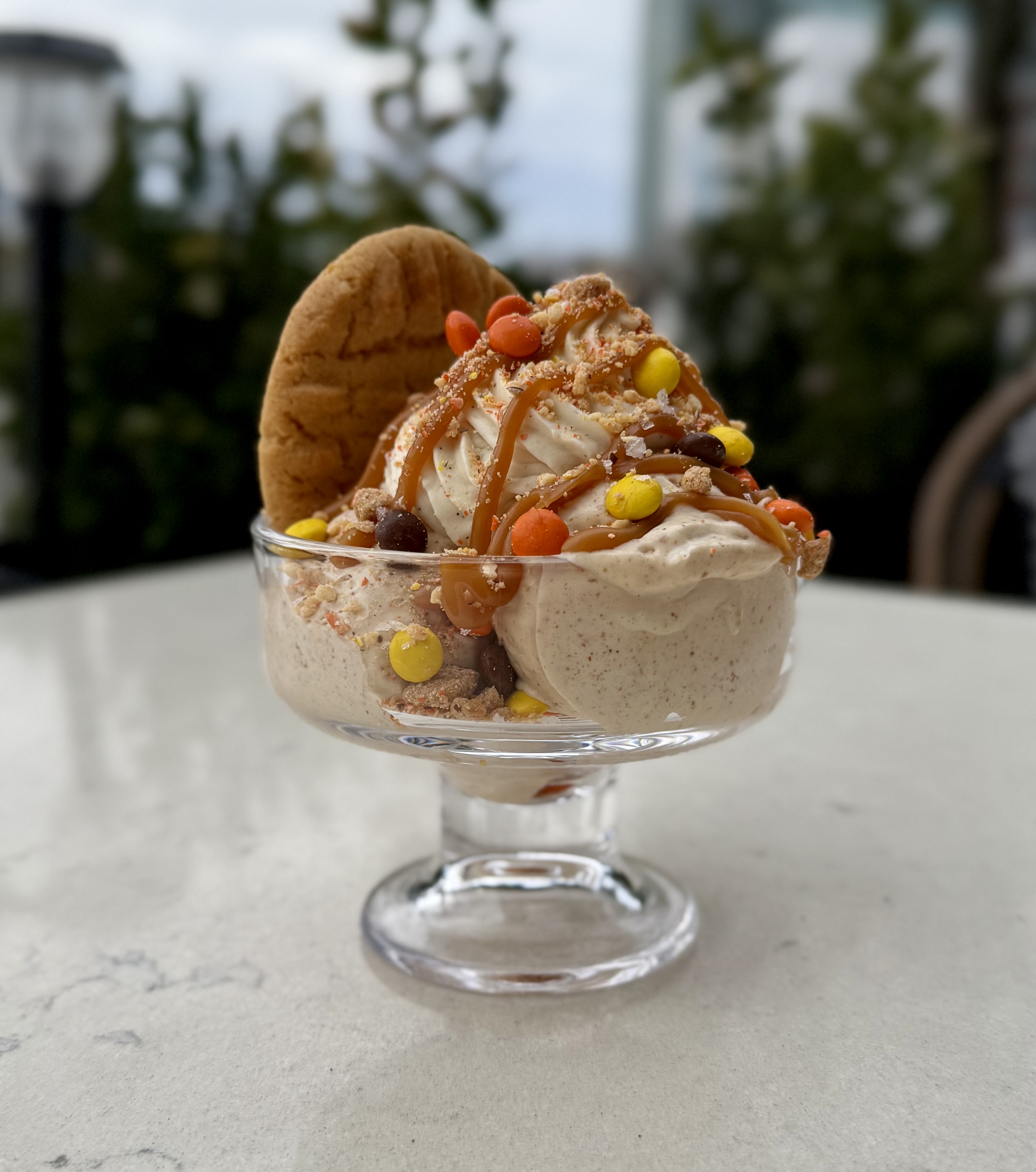 a bowl of ice cream with cookies and candy
