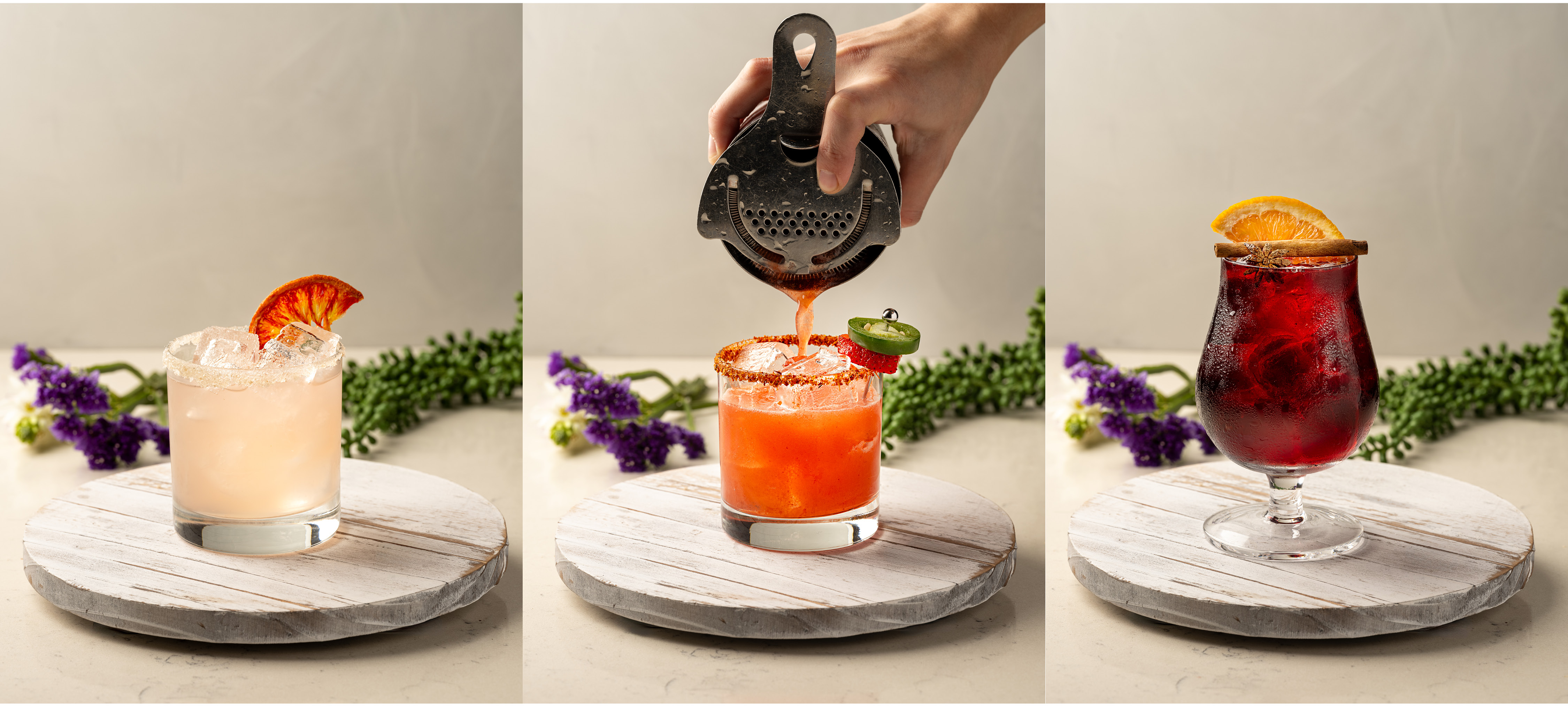 a hand squeezing a juice into a glass