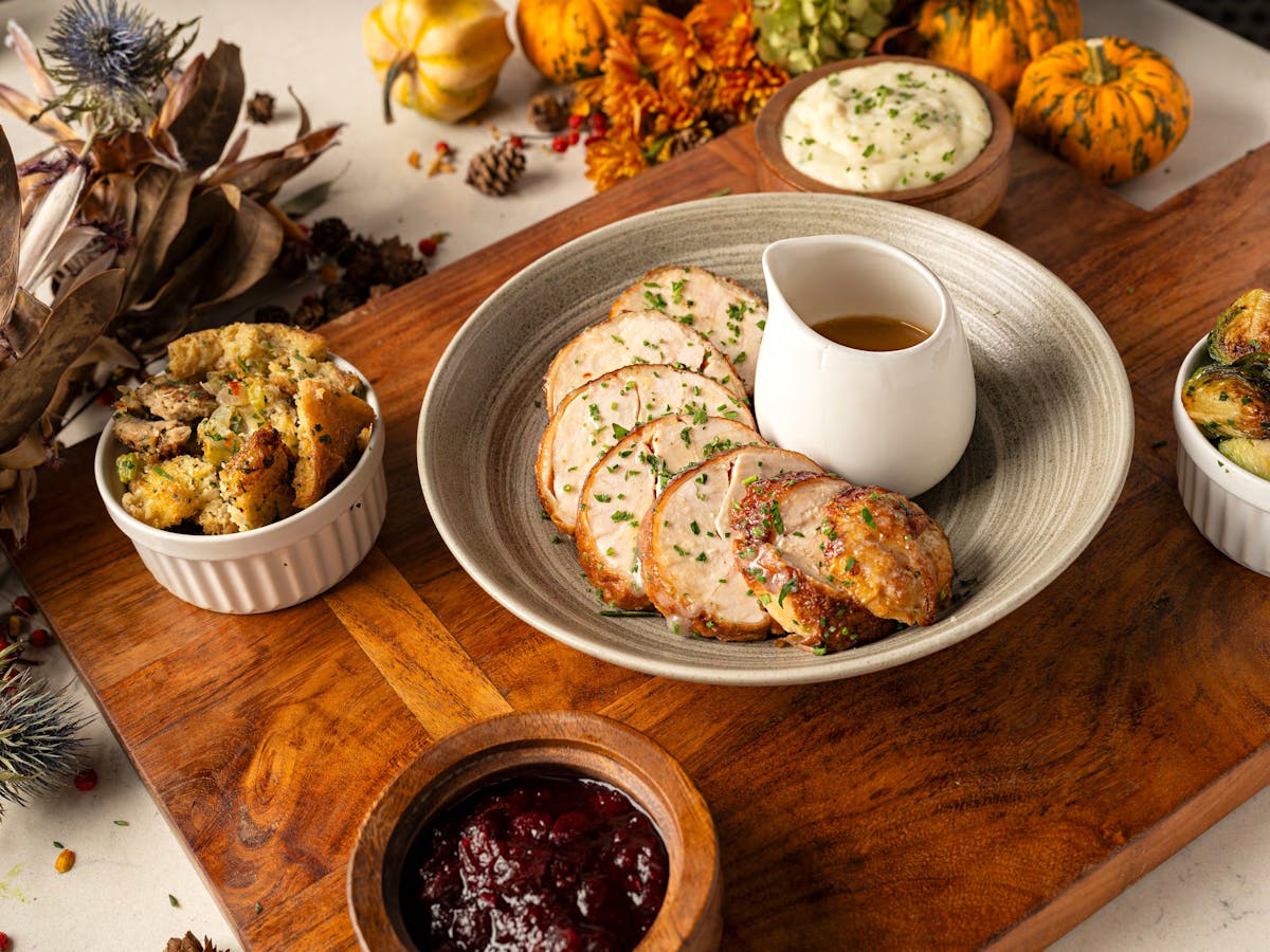 a wooden table topped with plates of food on a plate