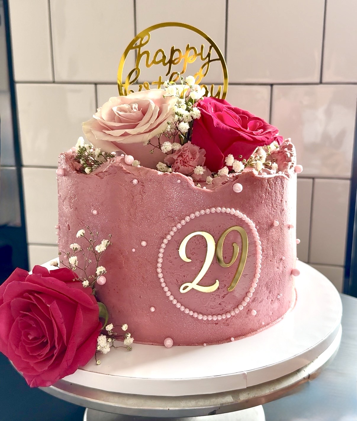 a pink cake with flowers