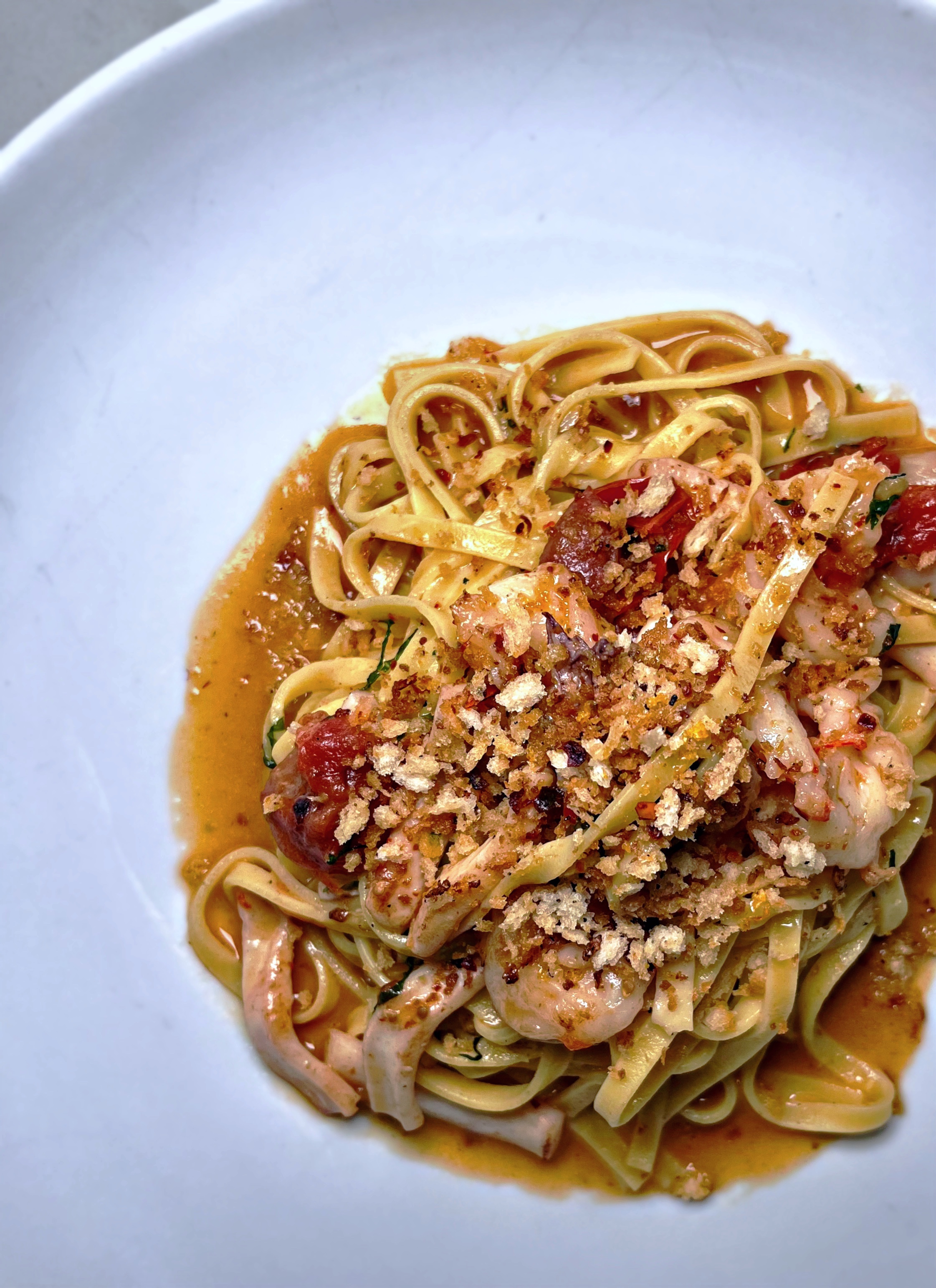 a plate of pasta with sauce and cheese