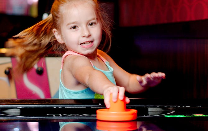 a little girl sitting on a table