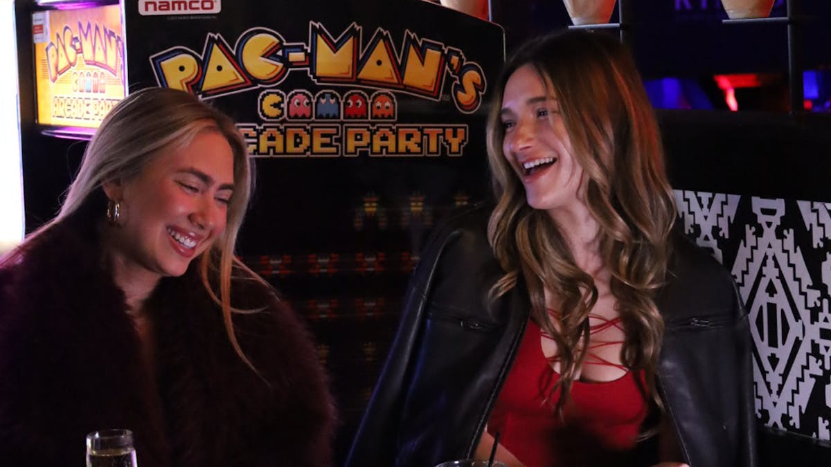 Two girls playing video games at Kings