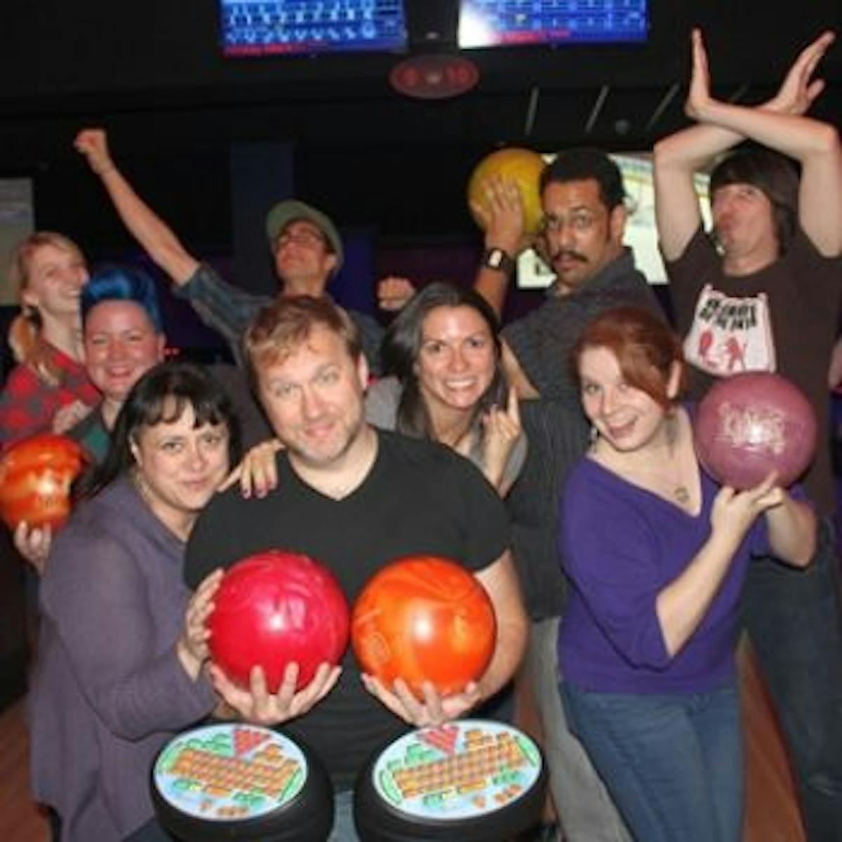 a group of people standing in front of a crowd posing for the camera