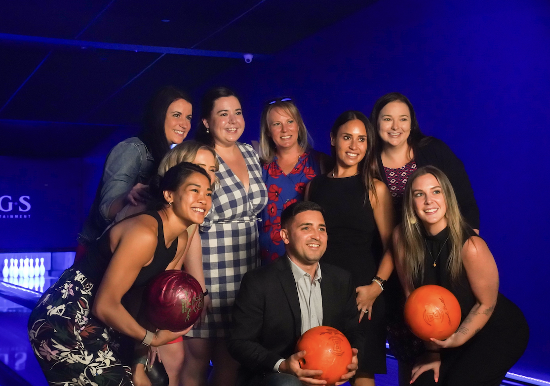 a group of people standing on a stage posing for the camera
