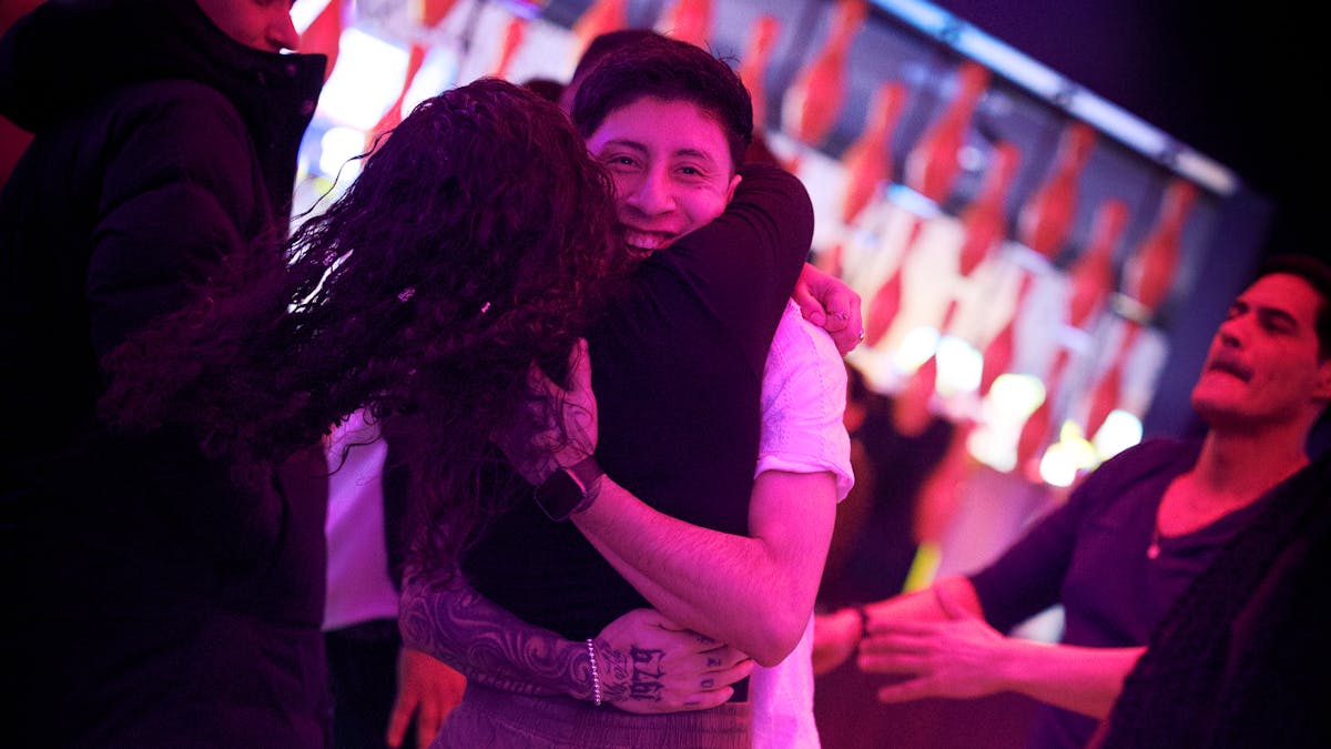 A couple hugging while bowling at Kings