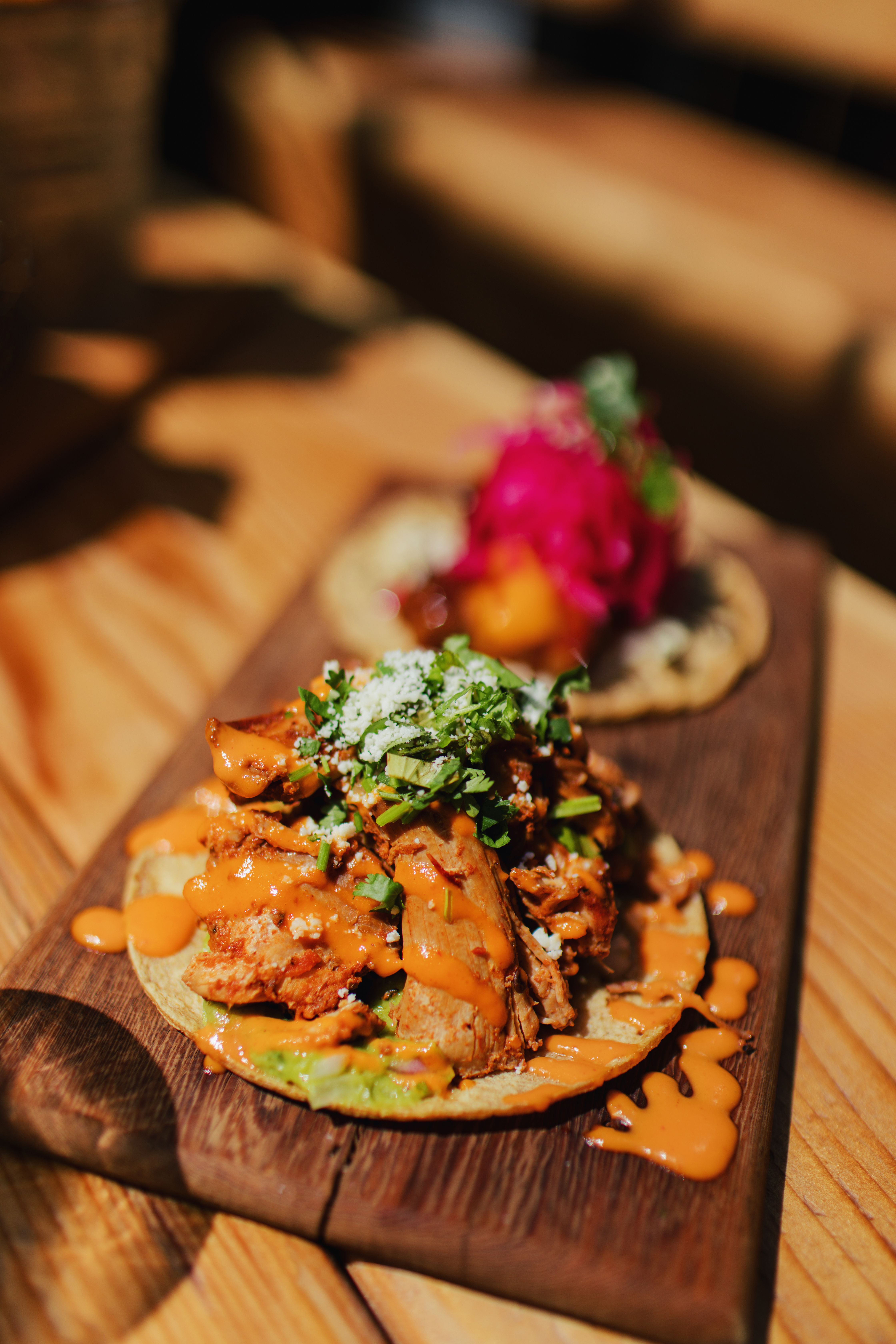 Chicken Tinga Taco with cilantro and cheese at Dos Santos