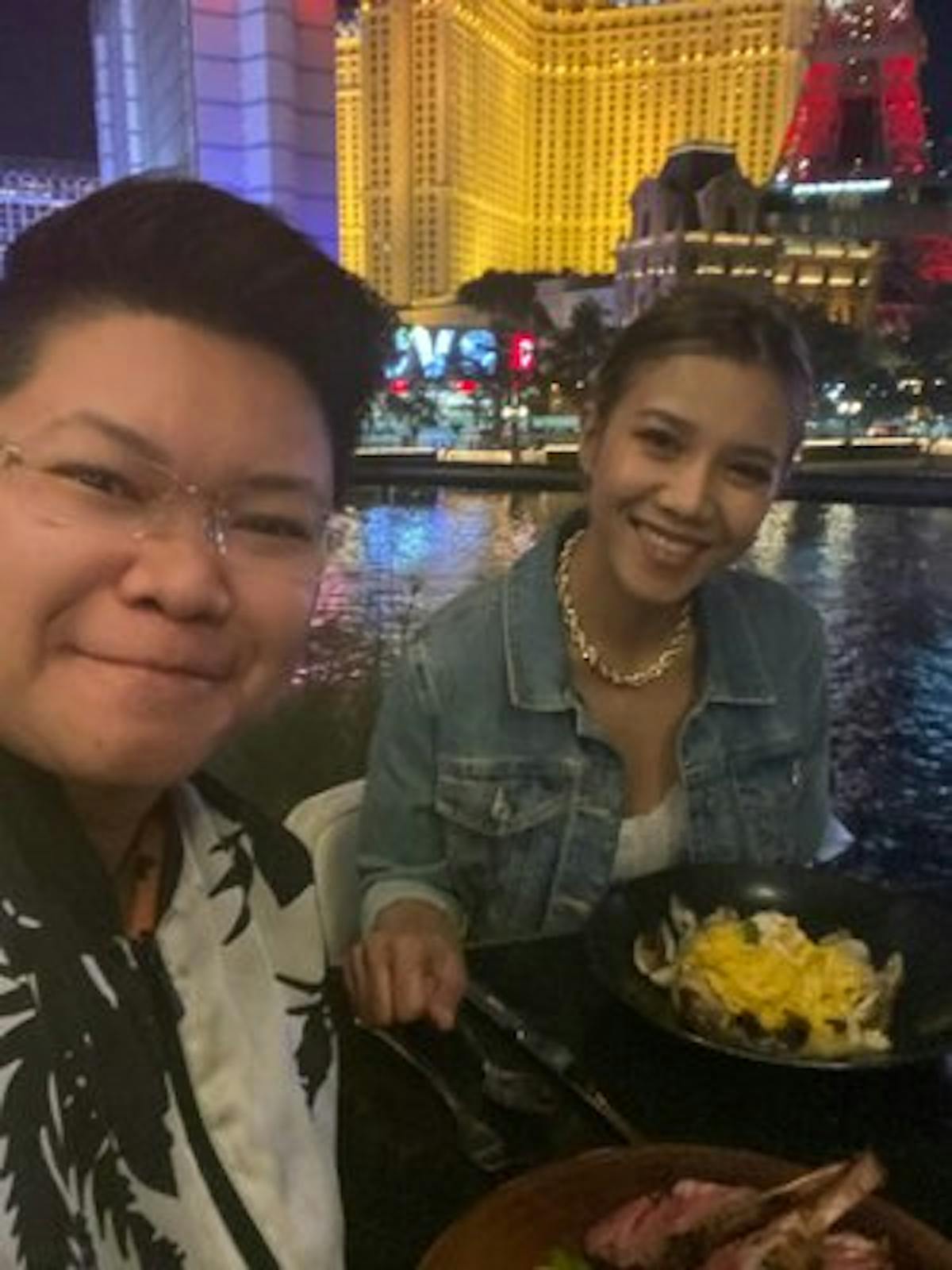 a woman sitting at a table with a plate of food