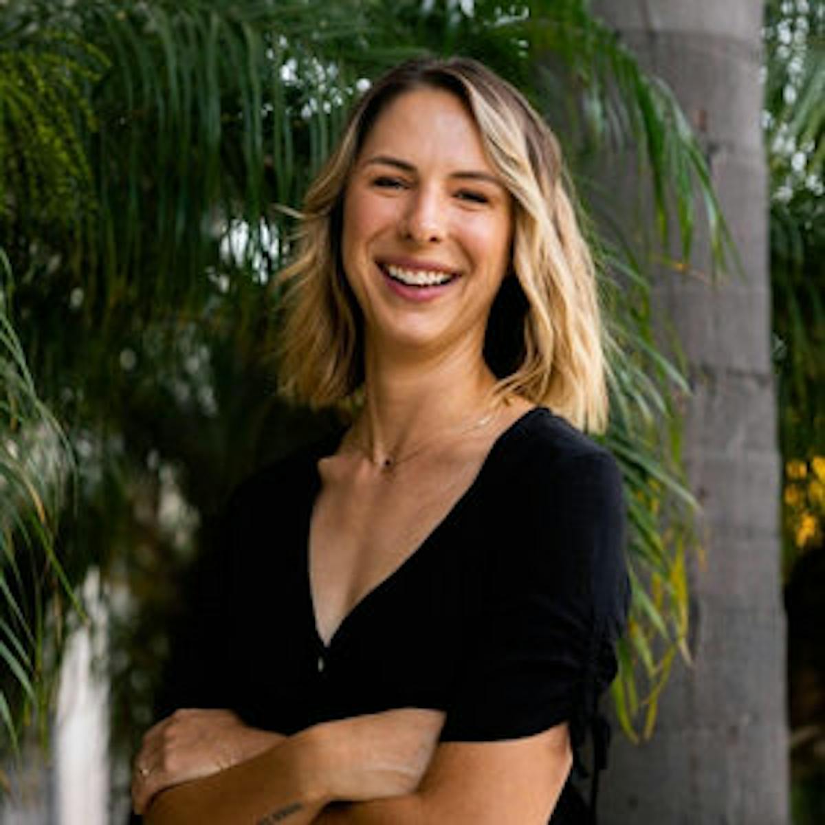 a woman standing in front of a tree