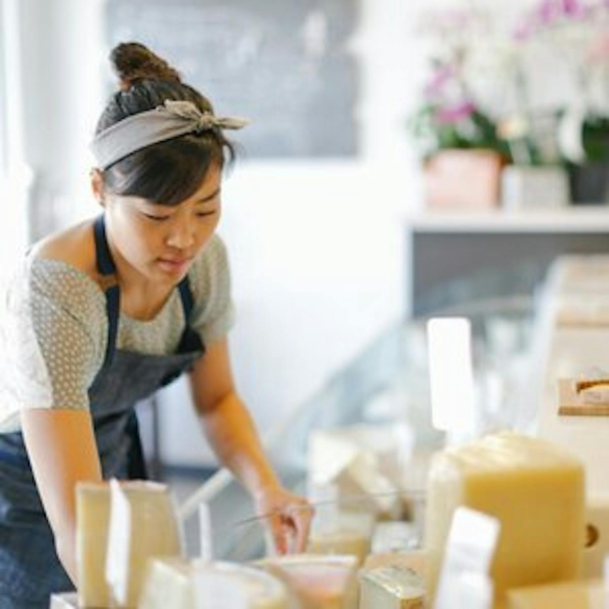 a woman preparing food in a kitchen